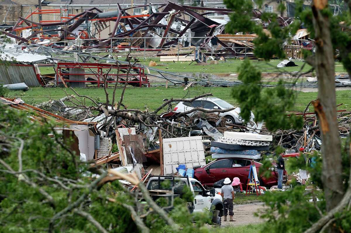 VAN, TX - MAY 11: Volunteers and officials search through the destruction near Van Intermediate School after a tornado May 11, 2015 in Van, Texas. The small city of Van, Texas was struck by a tornado in the evening of May 10, leaving at least two dead and more missing. (Photo by Ron Jenkins/Getty Images)