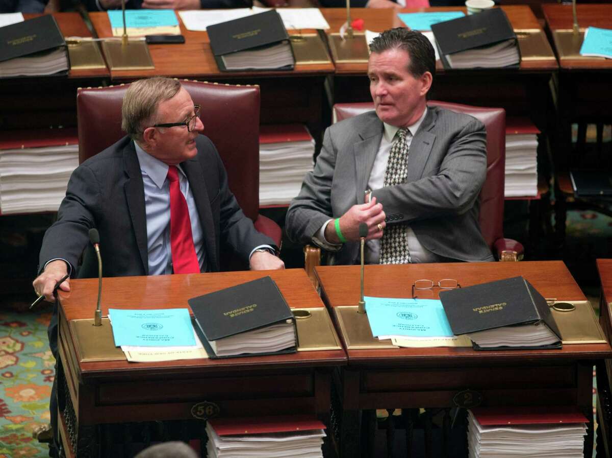 Sen. John DeFrancisco, R-Syracuse, left, and Sen. John Flanagan, R-Smithtown, talk in the Senate Chamber at the Capitol on Monday, May 4, 2015, in Albany, N.Y. (AP Photo/Mike Groll) ORG XMIT: NYMG105