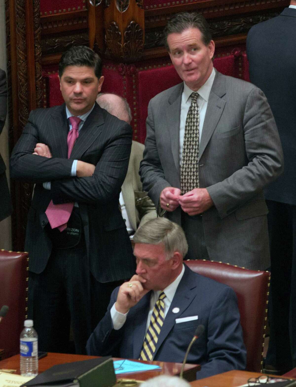 Sen. John Flanagan, R-Smithtown, right, talks with Sen. George Amedore, R-Rotterdam, in the Senate Chamber at the Capitol on Monday, May 4, 2015, in Albany, N.Y. Sen. Rich Funke, R-Fairport, is seated. (AP Photo/Mike Groll) ORG XMIT: NYMG111