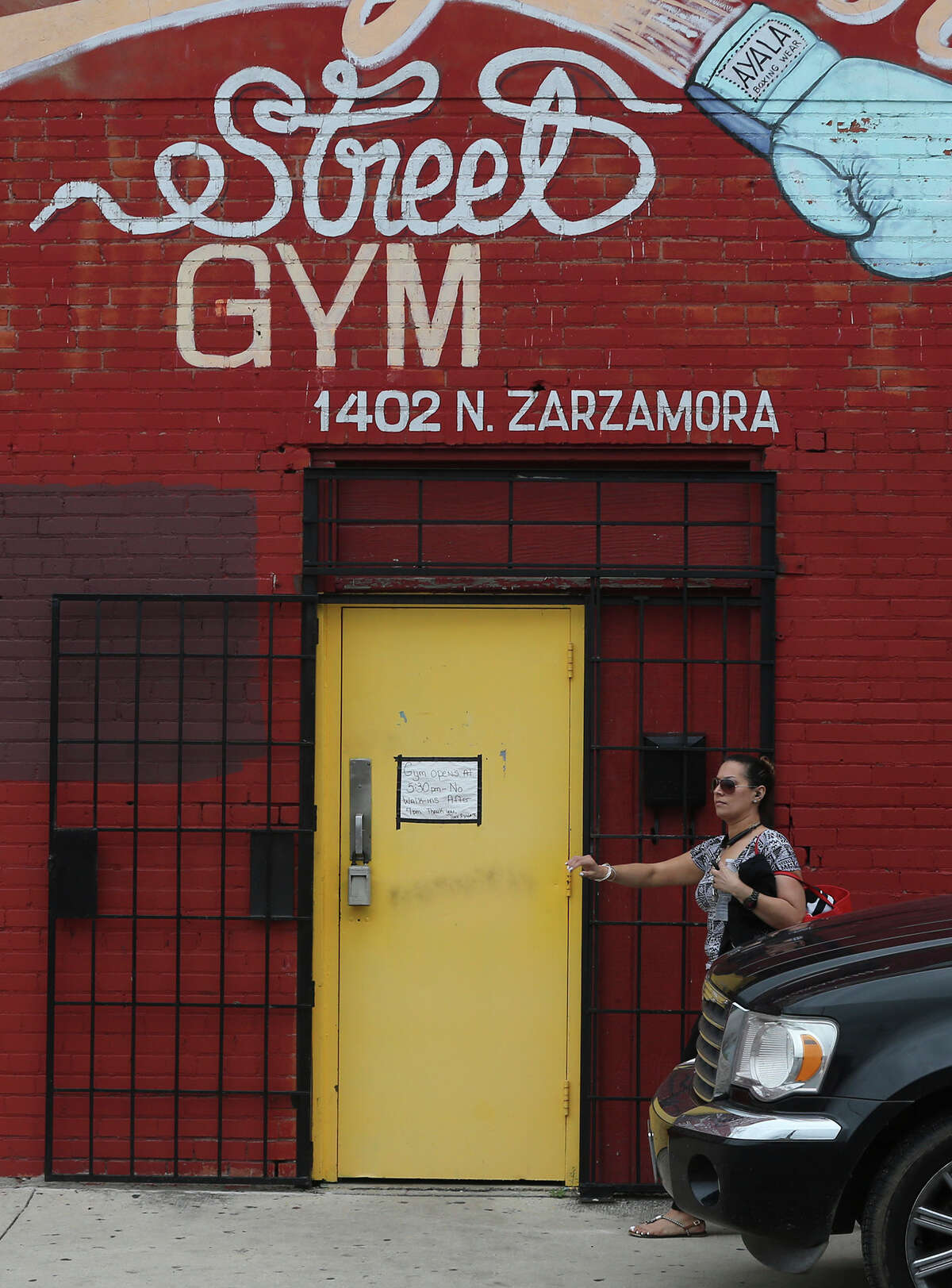 A woman enters the Zarzamora Street Gym on May 12 where Tony Ayala Jr.died.