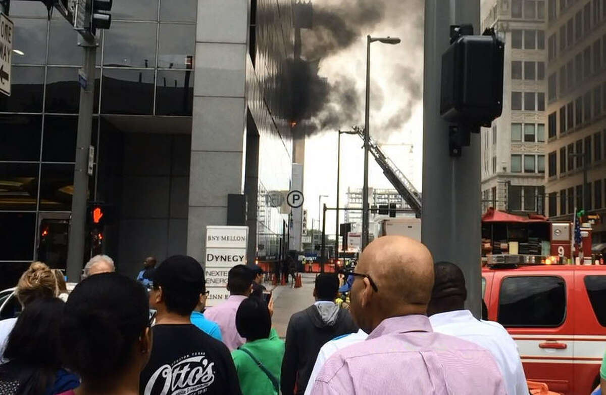 Employees in the Chase Tower downtown were evacuated Tuesday after several cars caught fire in the parking garage.