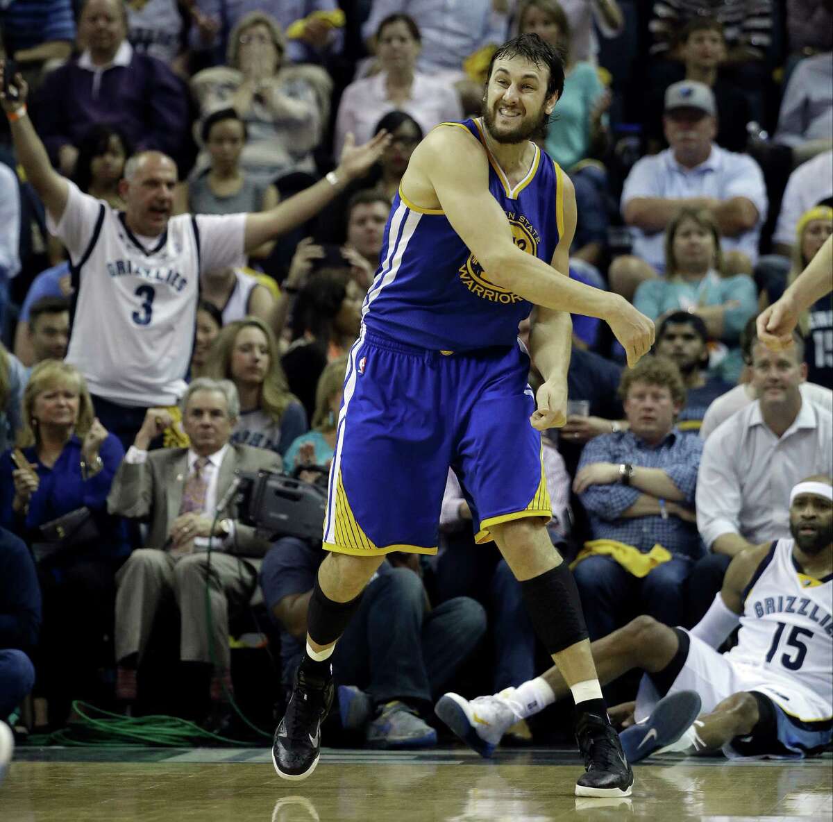 Golden State Warriors center Andrew Bogut (12) throws the ball down court as Memphis Grizzlies guard Vince Carter (15) sits on the floor in the first half of Game 4 of a second-round NBA basketball Western Conference playoff series Monday, May 11, 2015, in Memphis, Tenn. (AP Photo/Mark Humphrey)