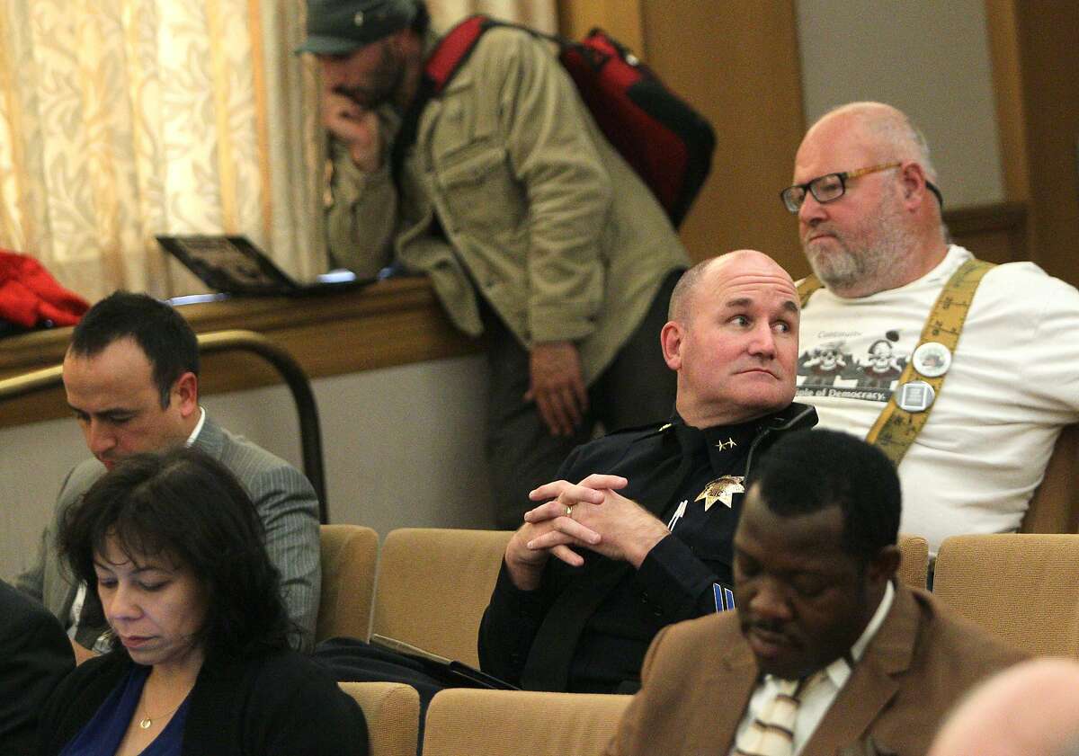Audience members listen in to the Oakland City Council during a public hearing at Oakland City Hall, Tuesday, May 12, 2015, in Oakland, Calif. The council postponed the vote of a controversial privacy policy for the city's Domain Awareness Center, a surveillance hub at the Port of Oakland that collects and monitors video feeds in order to protect the port from security threats, until their next committee meeting. The council still allowed the public to comment on the policy.