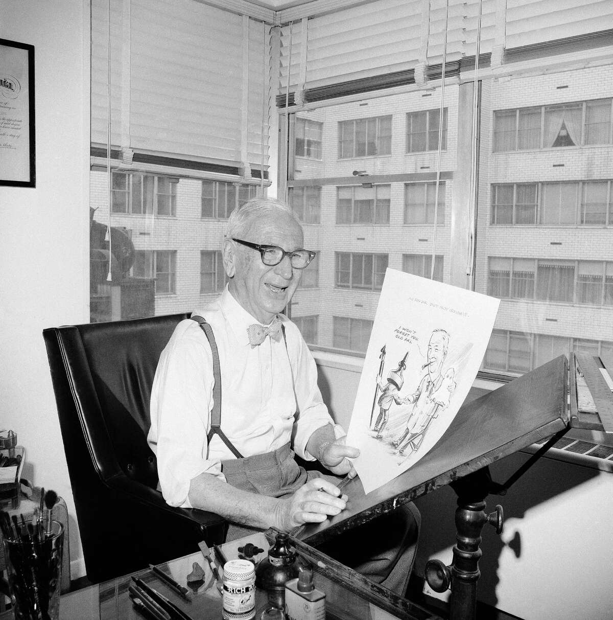 Cartoonist Rube Goldberg, 81, is shown in his New York City apartment, April 24, 1964 after he completed his last cartoon, which showed him bidding goodbye to a cartoonist’s pen and ink bottle. He draws the cartoon to mark his resignation as a King Features cartoonist, and said at the time he planned to devote the rest of his life to sculpture. (AP Photo/John Lindsay)