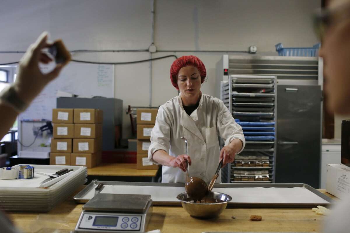 Claire Keane, owner, works with melted chocolate in the production kitchen at Clairesquares on Tuesday, May 6, 2015 in Sausalito, Calif.