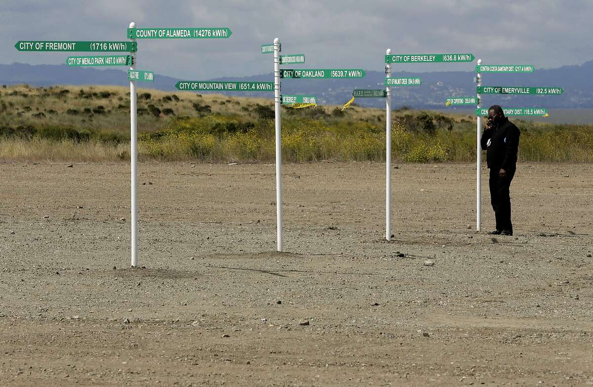 Andre Benson with Alameda County Services along a row of signs showing Bay Area cities and counties associated with the nation's first federal solar partnership, which was announced by United States EPA Administrator Gina McCarthy during a visit to the West Winton Landfill property in Hayward, Calif., on Wed. May 13, 2015. Plans are to install 19,000 solar panels on the landfill site.
