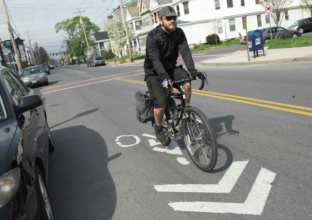 Oliver Leue of Albany bicycles to work down Delaware Avenue on Thursday May 8, 2014 in Albany, N.Y. (Michael P. Farrell/Times Union archive)