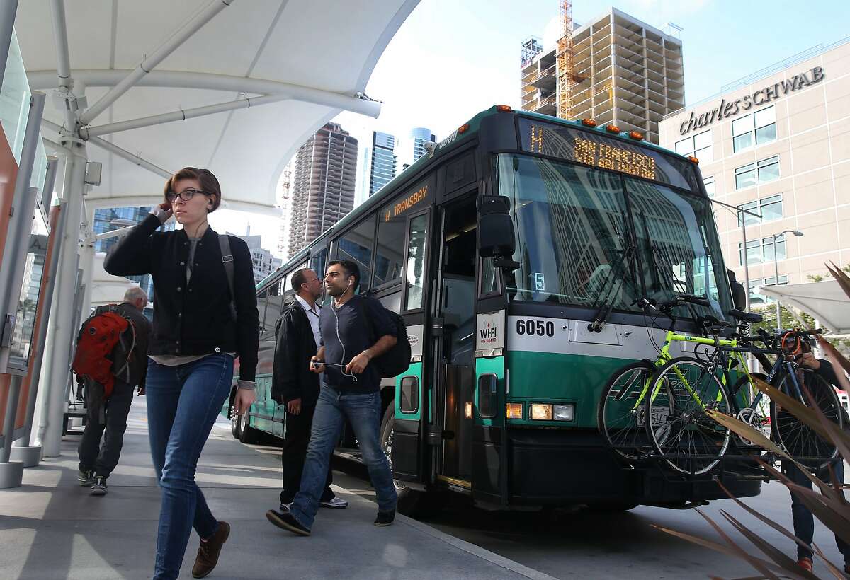 Passengers exit an AC Transit bus after commuting from the East Bay in San Francisco, Calif. on Thursday, May 14, 2015. Transit planners are exploring the possibility of converting one of the eastbound lanes on the Bay Bridge into a single transit-only lane for westbound buses during the morning commute. The idea is that buses would bypass congested rush hour traffic.