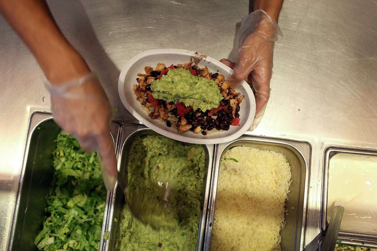 MIAMI, FL - APRIL 27: Chipotle restaurant workers fill orders for customers on the day that the company announced it will only use non-GMO ingredients in its food on April 27, 2015 in Miami, Florida. The company announced, that the Denver-based chain would not use the GMO's, which is an organism whose genome has been altered via genetic engineering in the food served at Chipotle Mexican Grills. (Photo by Joe Raedle/Getty Images)