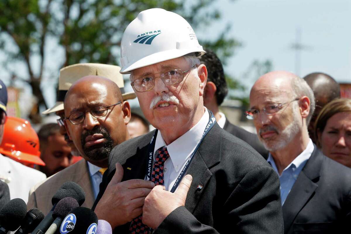 As Philadelphia Mayor Michael Nutter, left, and Pennsylvania Gov. Tom Wolf, right, listen Amtrak CEO, Joseph Boardman expresses his sorrow near the site of a deadly train derailment Thursday, May 14, 2015, in Philadelphia. An Amtrak train headed to New York City derailed and crashed in Philadelphia on Tuesday night killing eight people and and sending more than 200 passengers and crew to area hospitals. Investigators have said the Amtrak passenger train was going more than twice the allowed speed when it shot off a sharp curve. (AP Photo/Mel Evans) ORG XMIT: PAME112