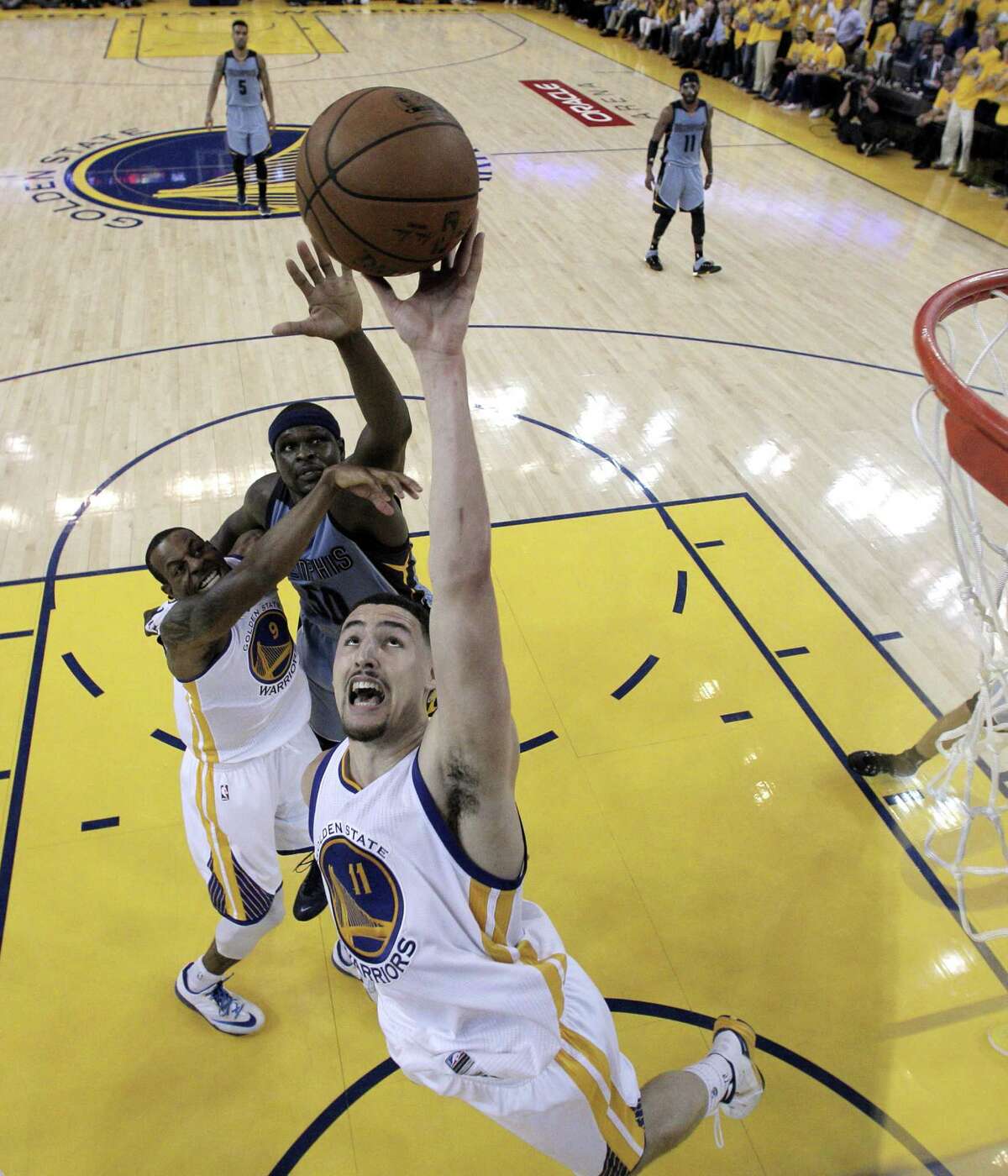 OAKLAND, CA - MAY 13: Klay Thompson #11 of the Golden State Warriors goes up for a rebound against the Memphis Grizzlies during Game Five of the Western Conference Semifinals of the NBA Playoffs at ORACLE Arena on May 13, 2015 in Oakland, California. NOTE TO USER: User expressly acknowledges and agrees that, by downloading and or using this photograph, User is consenting to the terms and conditions of the Getty Images License Agreement. (Photo by Carlos Gonzalez - Pool /Getty Images)