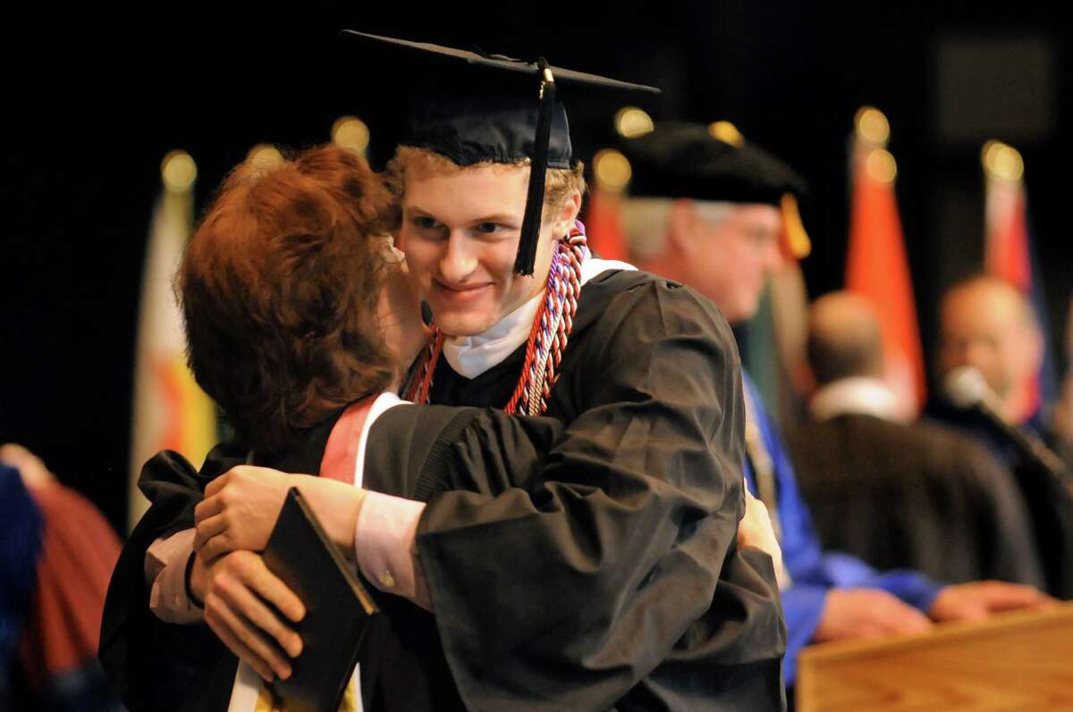 Graduate Connor Grant-Knight, right, celebrates the moment with a faculty member during Skidmore College commencement exercises on Saturday, May 16, 2015, at Saratoga Performing Arts Center in Saratoga Springs, N.Y. (Cindy Schultz / Times Union)