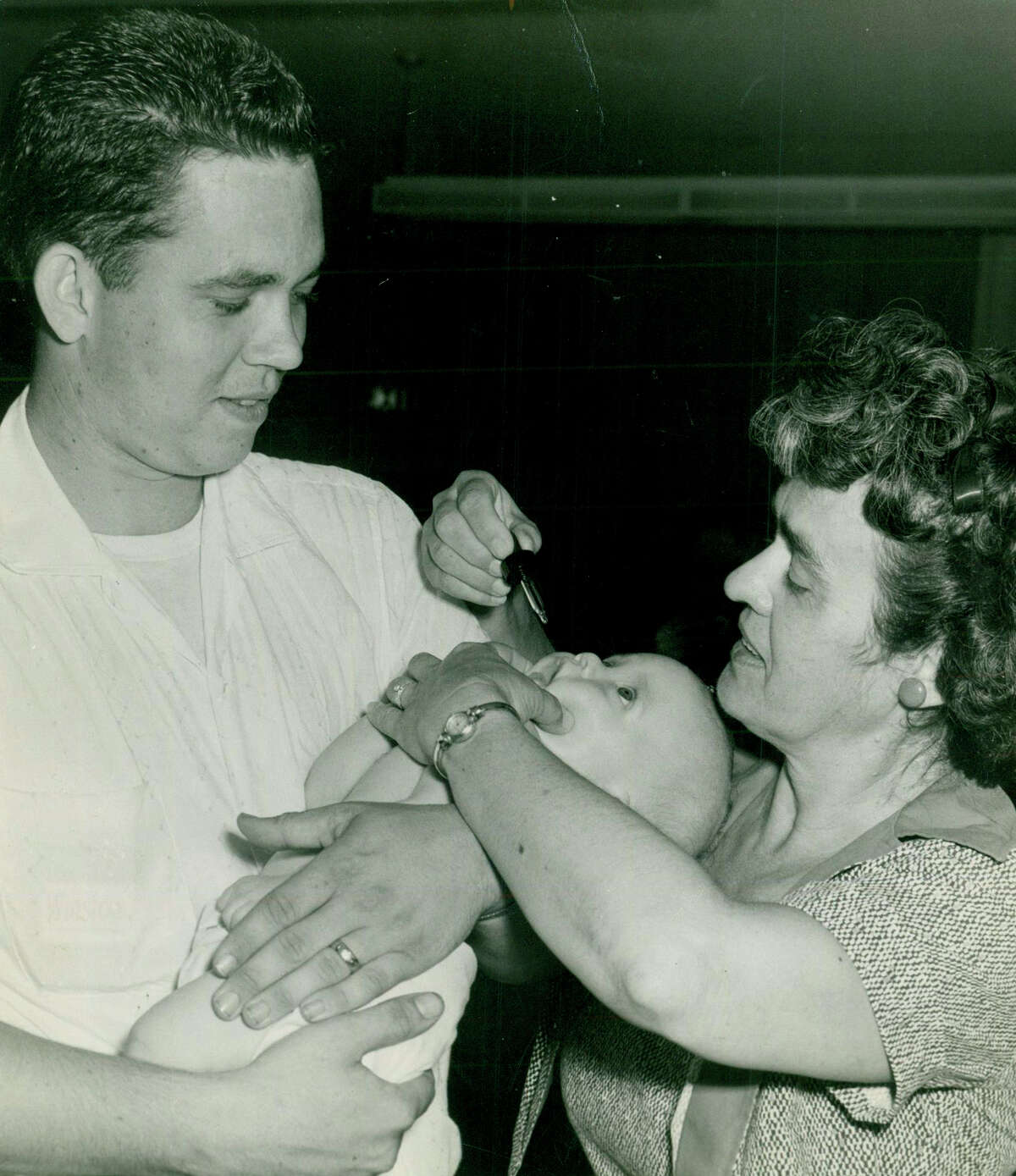 In this 1962 file photo, Ronald James Hicks, then 4 months old, received a polio vaccation from registered nurse D.S. Overman, right.