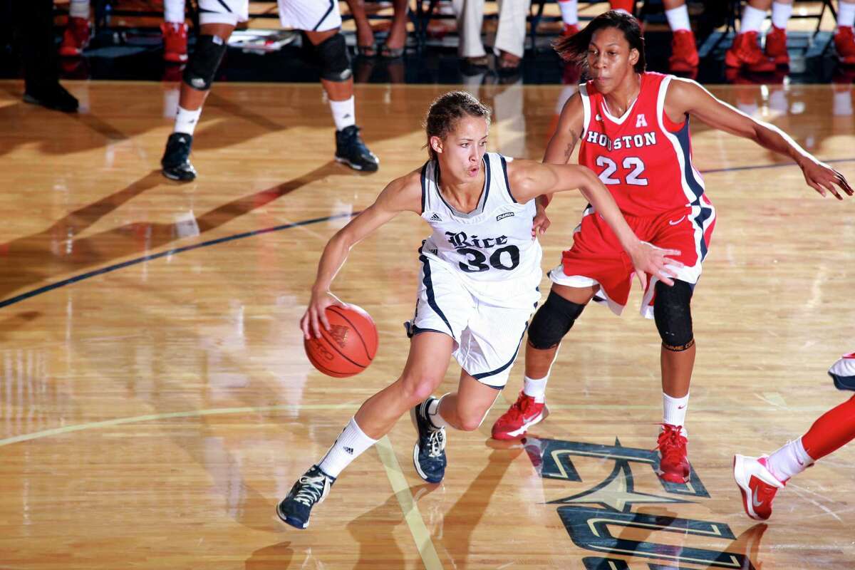 Rice University guard Jessica Kuster, left, moves the ball downcourt during a game against Houston. The Reagan High School graduate not only set Conference USA records for double-doubles and rebounds over her career, she was also the first player to make all-conference first team and all-defensive team for four years.