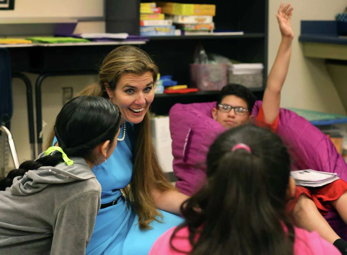 Amy Garza, the academic readiness coach at Southwest ISD’s Bob Hope Elementary School, engages with students during a circle meeting at the highly ranked school in Southwest ISD. “We check homework, make sure they’re ready to go, make sure they have pencils,” said Garza, whose students call her “Mama Garza.”