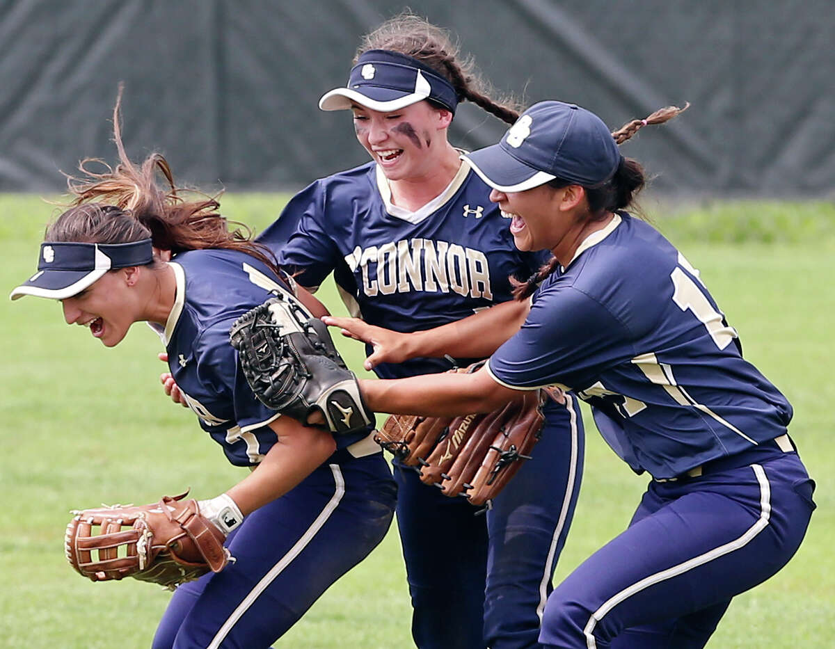 O’Connor’s Alex Scheel (from left) celebrates with teammates Kristen McKenzie, and Khylea Davila after catching a fly ball for the final out against Corpus Christi Carroll in Game 2 of the Class 6A best-of-3 third-round high school softball playoff series on May 16, 2015 at Northside ISD Complex.