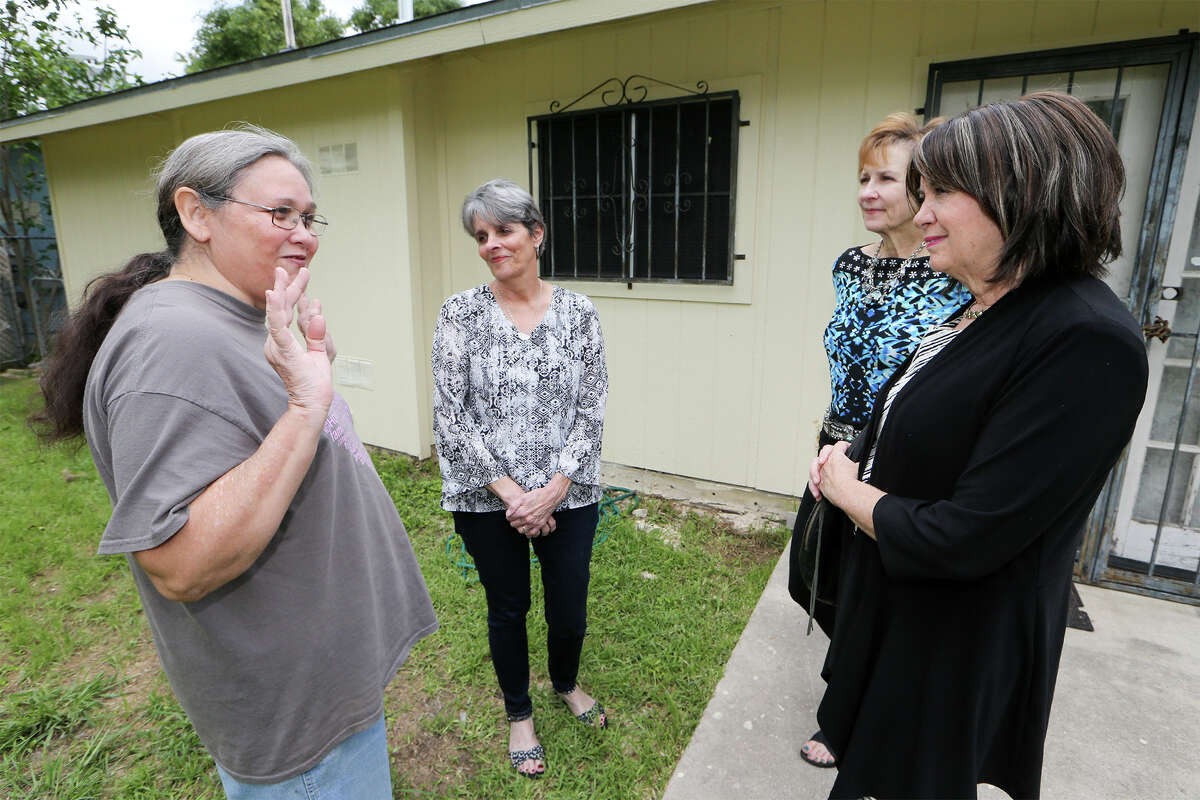 Donna Harrison (from right), President of Impact San Antonio, Jeanne Albrect, board member of Impact San Antonio and Dee Dee Sedgwick, Executive Director of Blueprint Ministries visit with Ramona Alcarez outside her home on Tuesday, April 28, 2015. Blueprint Ministries is in the process of making to repairs to the Alcarez residence with funds provided by Impact San Antonio. MARVIN PFEIFFER/ mpfeiffer@express-news.net