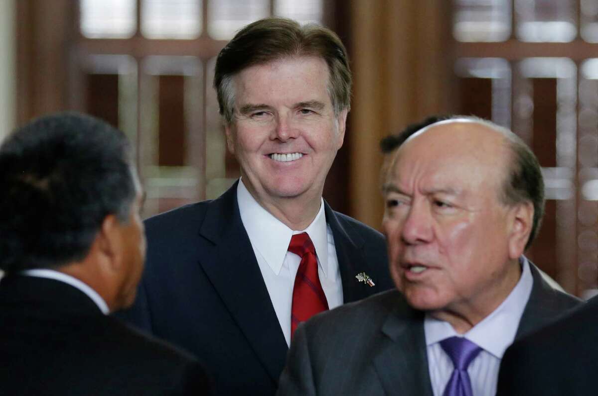 Texas Lt. Gov. Dan Patrick, center, talks to a guest in the Senate Chamber, Tuesday, May 5, 2015, in Austin, Texas. Under a bill that has cleared the Republican-controlled Senate Tuesday, most abortions in Texas could not be covered by insurance purchased through the Affordable Care Act. (AP Photo/Eric Gay)