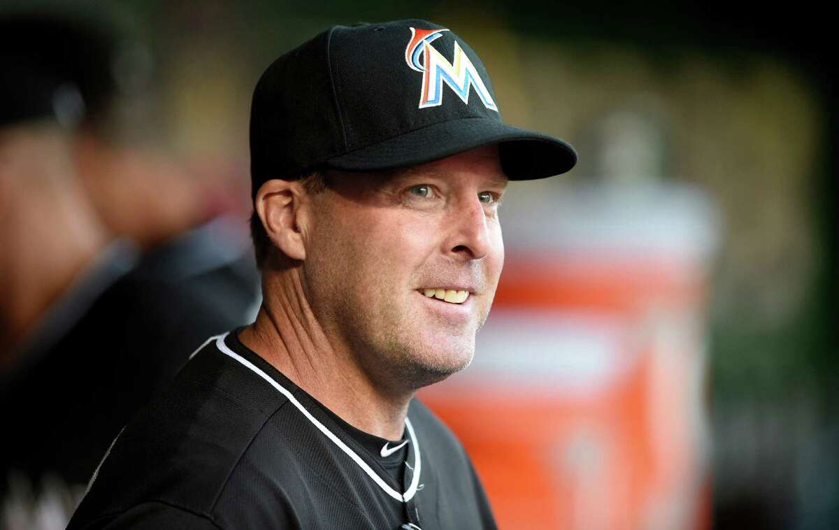 Miami Marlins manager Mike Redmond (11) looks on from the dugout before a baseball game against the Washington Nationals, Monday, May 4, 2015, in Washington. (AP Photo/Nick Wass)