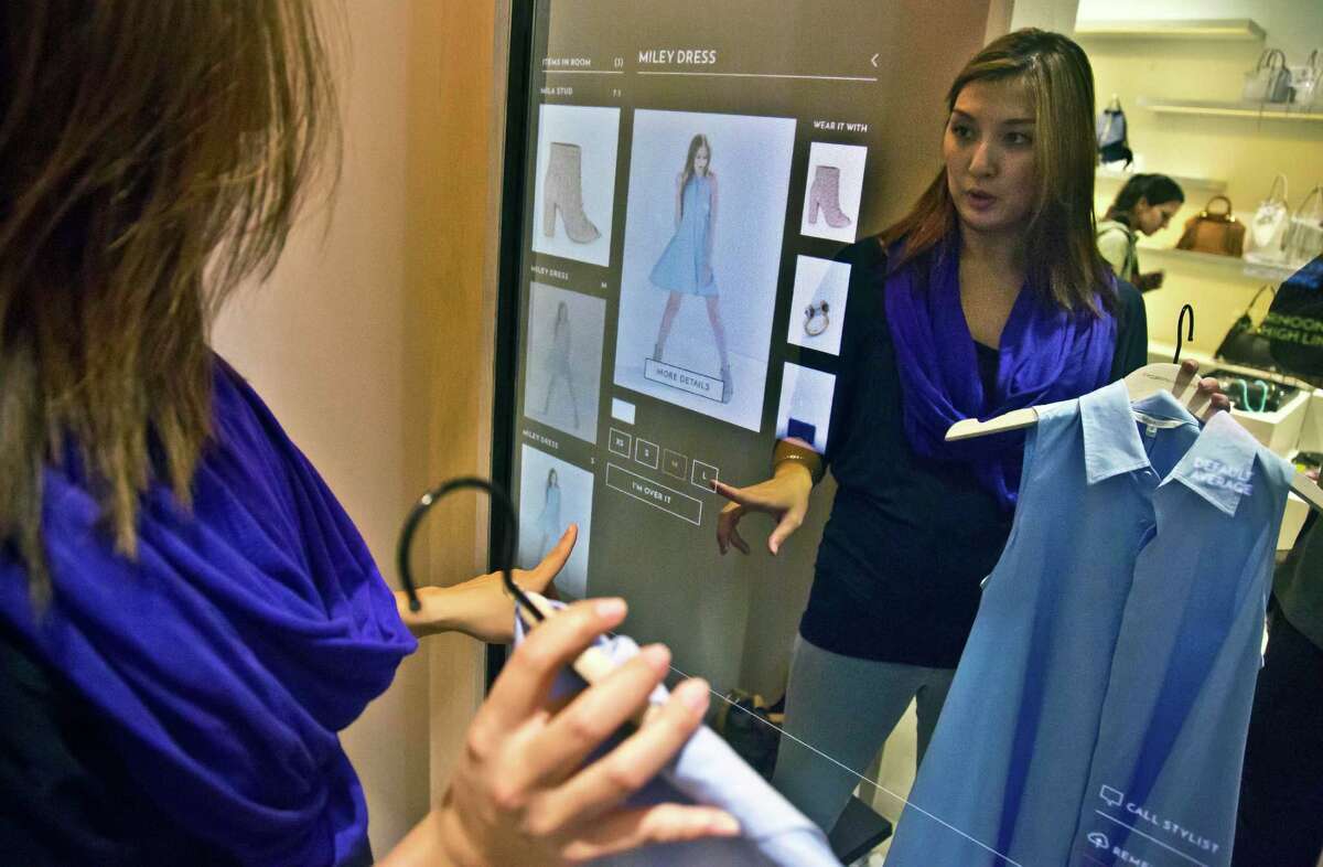 Christie McAllister, visiting from San Francisco, prepares to use a fitting room equipped with eBay's touch-screen fitting room technology at Rebecca Minkoff in New York. The interactive technology provides a virtual assistant inside fitting rooms for shoppers, displaying their selections and a catalog to modify choices and accessorize.