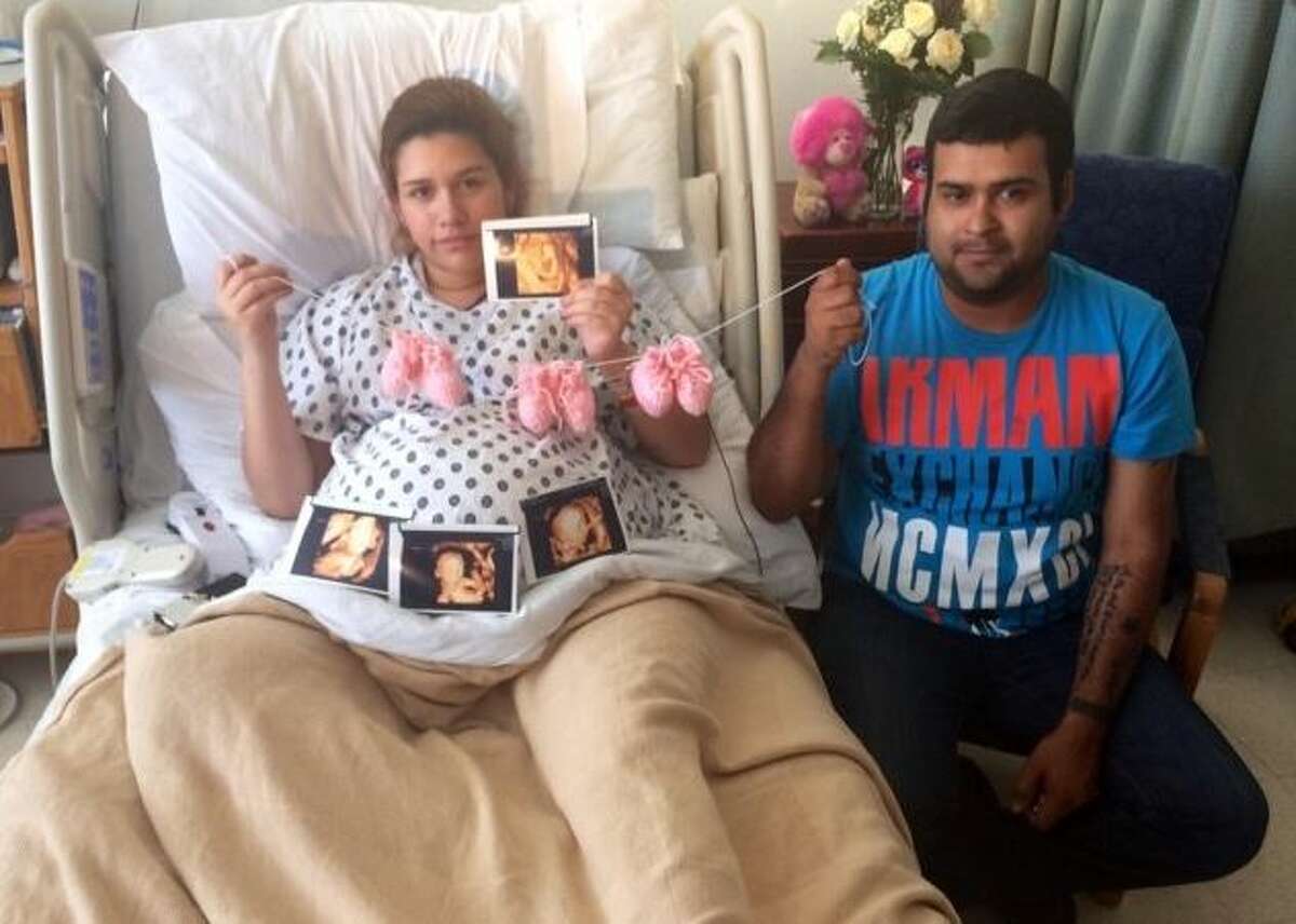 Silvia and Raul Torres hold the sonogram photos of their daughters, Catalina, Ximena and Scarlett. 