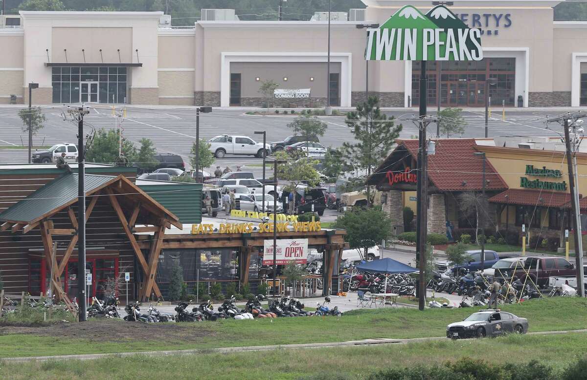 Law enforcement continue to investigate the motorcycle gang related shooting at the Twin Peaks restaurant, Monday, May 18, 2015, in Waco, Texas, where 9 were killed Sunday and over a dozen injured. Waco police on Monday announced the Texas Alcoholic Beverage Commission closed Twin Peaks for a week amid safety concerns. (AP Photo, Jerry Larson)