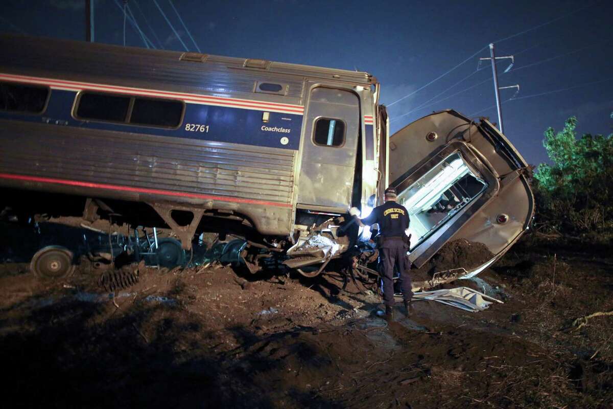 In this May 12, 2015 file photo, emergency personnel work the scene of a deadly train wreck in Philadelphia. Five years ago, federal safety officials proposed requiring video cameras in train cabs, but it didn't happen. That's left a gap as investigators try to unravel last week's fatal Amtrak derailment.