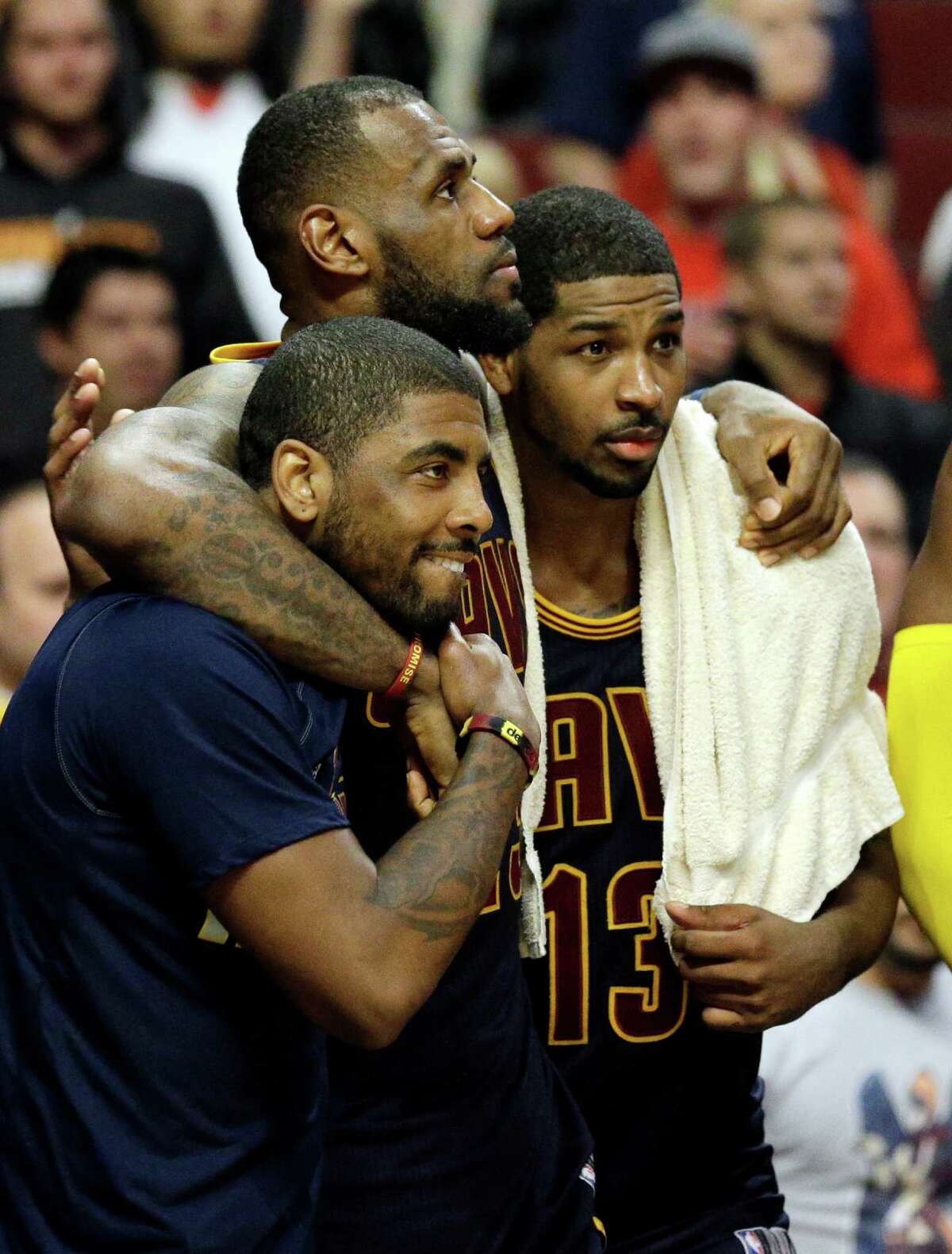 Cleveland Cavaliers forward LeBron James (center) watches the end of the game against the Chicago Bulls with guard Kyrie Irving (left) and center Tristan Thompson during the second half of Game 6 in a second-round playoff series in Chicago on May 14, 2015.