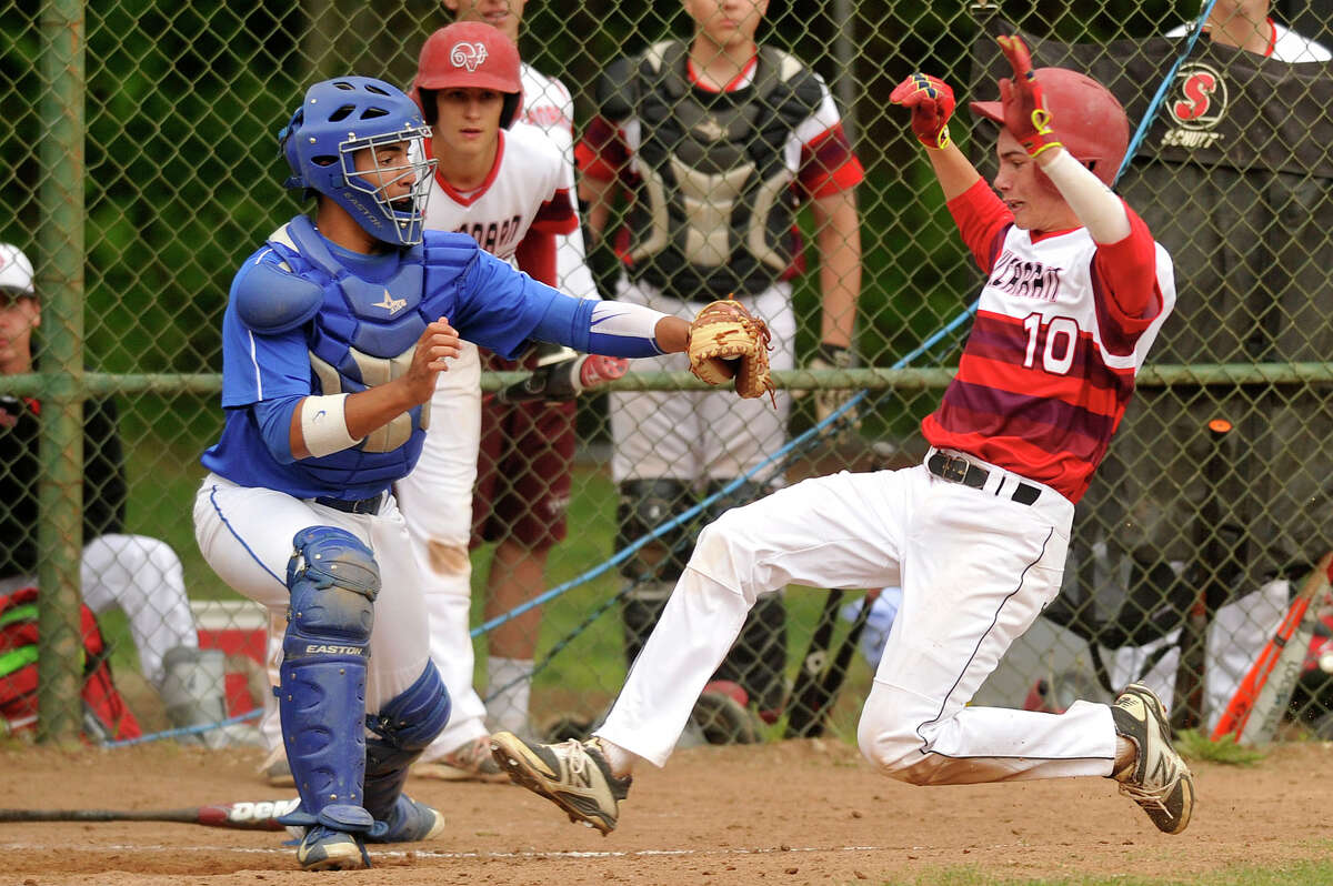 Darien catcher Anthony DiMeglio tags New Canaan's Kyle Levasseur out at home during their baseball game at Mead Park in New Canaan, Conn., on Monday, May 18, 2015. Darien won, 6-1.