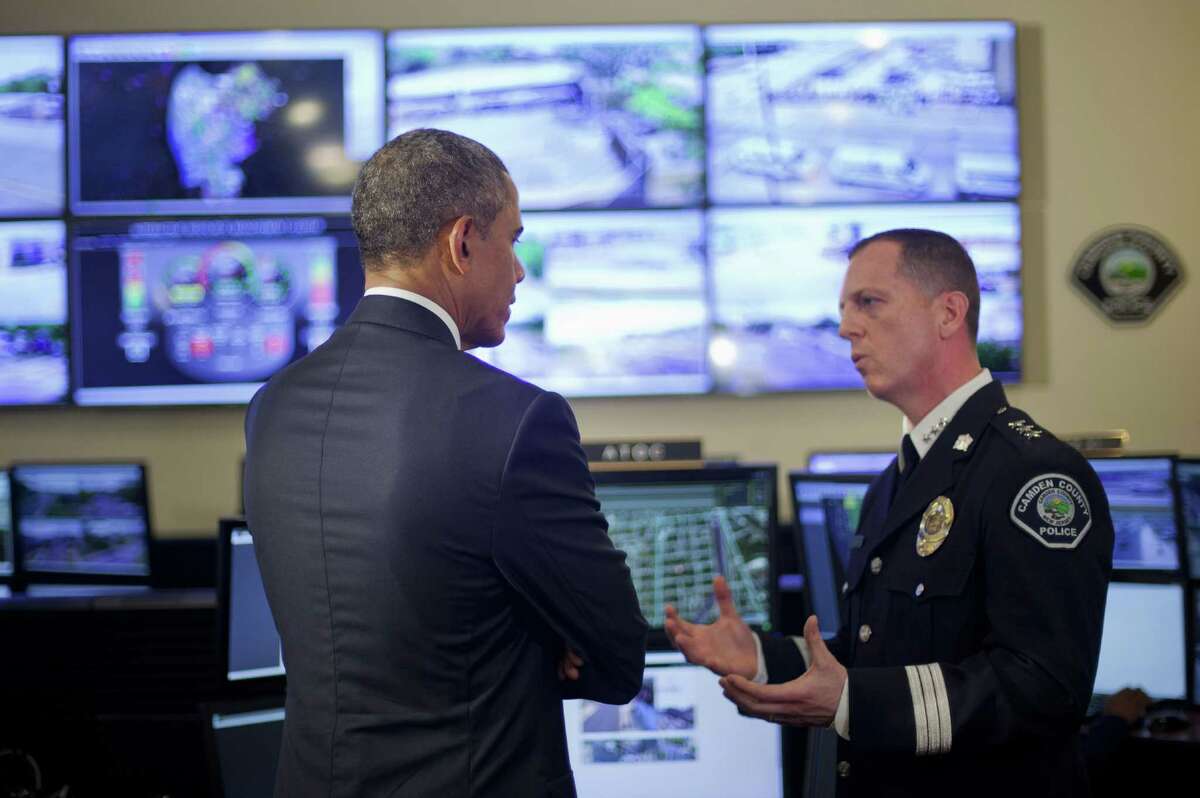 President Barack Obama is briefed by Camden's Police Chief J. Scott Thomson during a visit to Police Department's Real Time Tactical Operational Intelligence Center, Monday, May 18, 2015, in Camden, NJ. Obama traveled to Camden, NJ, to visit with local law enforcement and meet with young people in the Camden community. Obama also is announcing that he is prohibiting the federal government from providing some military-style equipment to local departments and putting stricter controls on other weapons and gear distributed to law enforcement. (AP Photo/Pablo Martinez Monsivais) ORG XMIT: NJPM110