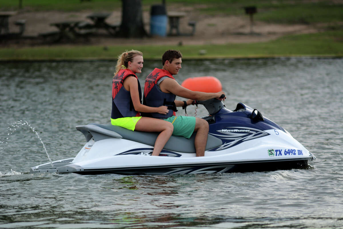 Jacob Anastasiades, of Navasota, celebrating his 21st birthday today, and Nickayla Floyd, 19, of Plantersville, ride a jet ski from Lake Conroe Water Sports at Papa's on the Lake on Lake Conroe Monday afternoon, May 18, 2015. Jacob is a student at Lone Star College - CyFair studying welding and Nickayla is a sophomore at Texas A&M majoring in Allied Health. (Photo by Jerry Baker/Freelance)