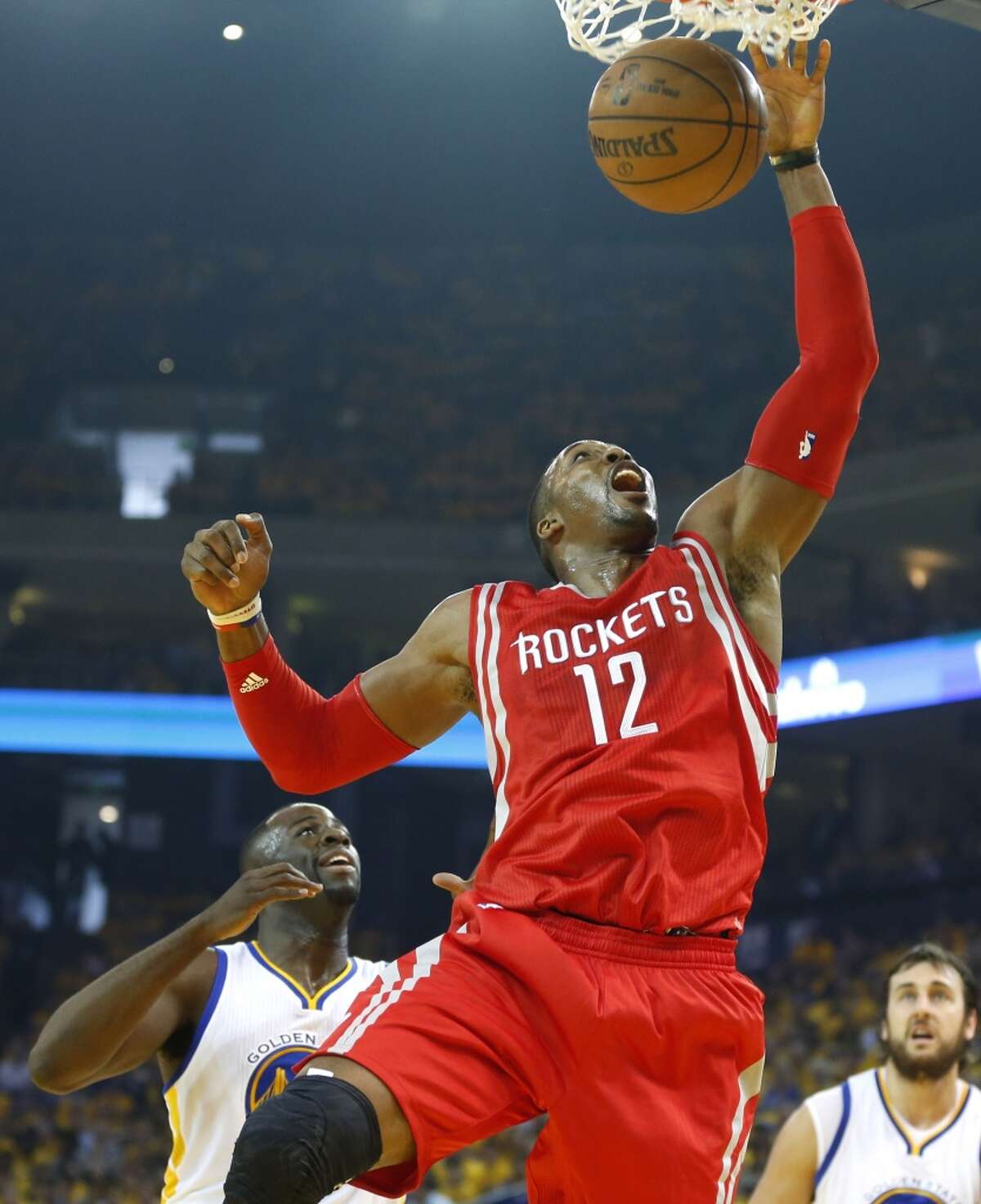 Houston Rockets center Dwight Howard (12) scores against the Golden State Warriors in the first period of Game 1 of the NBA Western Conference Finals at Oracle Arena on Tuesday, May 19, 2015, in Oakland. ( James Nielsen / Houston Chronicle )