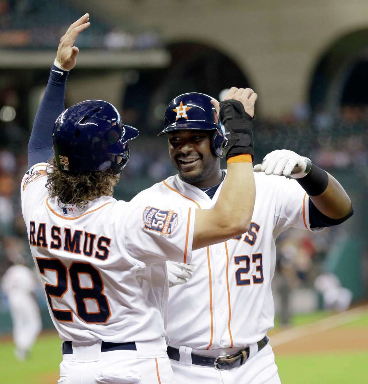 Houston Astros' Chris Carter (23) celebrates his two-run home run with Colby Rasmus (28) during the second inning of a baseball game against the Oakland Athletics on Tuesday, May 19, 2015, in Houston. (AP Photo/David J. Phillip)