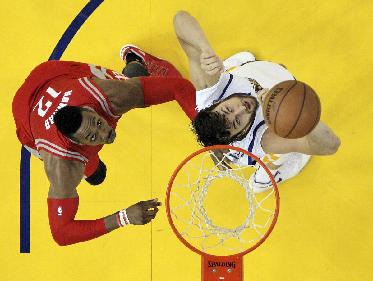 Andrew Bogut (12) and Dwight Howard (12) wait for a rebound to drop during the first half as the Golden State Warriors played the Houston Rockets in Game 1 of the Western Conference finals at Oracle Arena in Oakland, Calif., on Tuesday, May 19, 2015. The Warriors defeated the Rockets 110-106.
