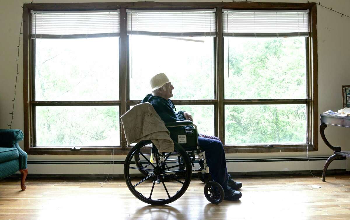 Lou Russo, 96, sits in his New Fairfield, Conn, home on Wednesday, May 20, 2015. Russo, a World War II veteran, was put in a nursing home by a court-order conservator, who also spent his life savings and rented his home to others. Russo got good news in probate court, the conservator has been ordered to pay him $34,000.