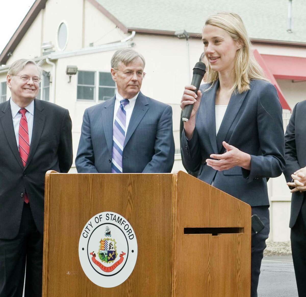 Stamford Mayor David Martin and Commissioner of Connecticut DOT James P. Redeker listen to State Representative Caroline Simmons speak about the new railroad crossing on Riverbend Drive South in Stamford. Thursday, May 21, 2015
