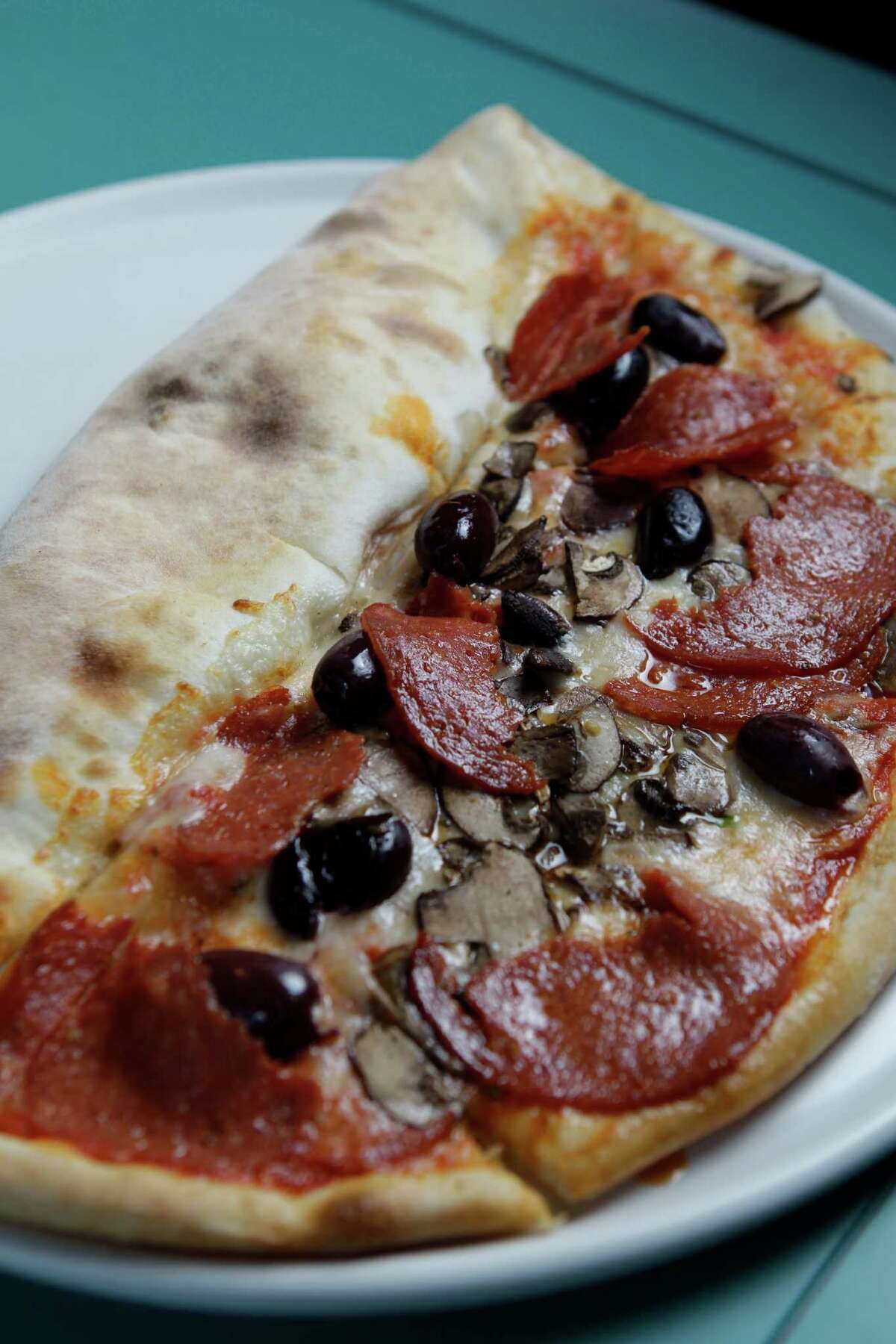 Mascalzone's namesake dish, a half-pizza and half-calzone