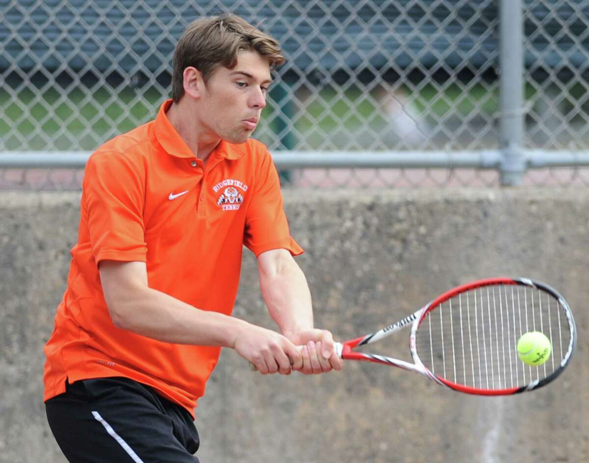 Ridgefield's Pat Delany volleys in his match against Greenwich's Marcos Eslava in the high school boys tennis match between Greenwich and Ridgefield at Greenwich High School in Greenwich, Conn. Thursday, May 21, 2015.