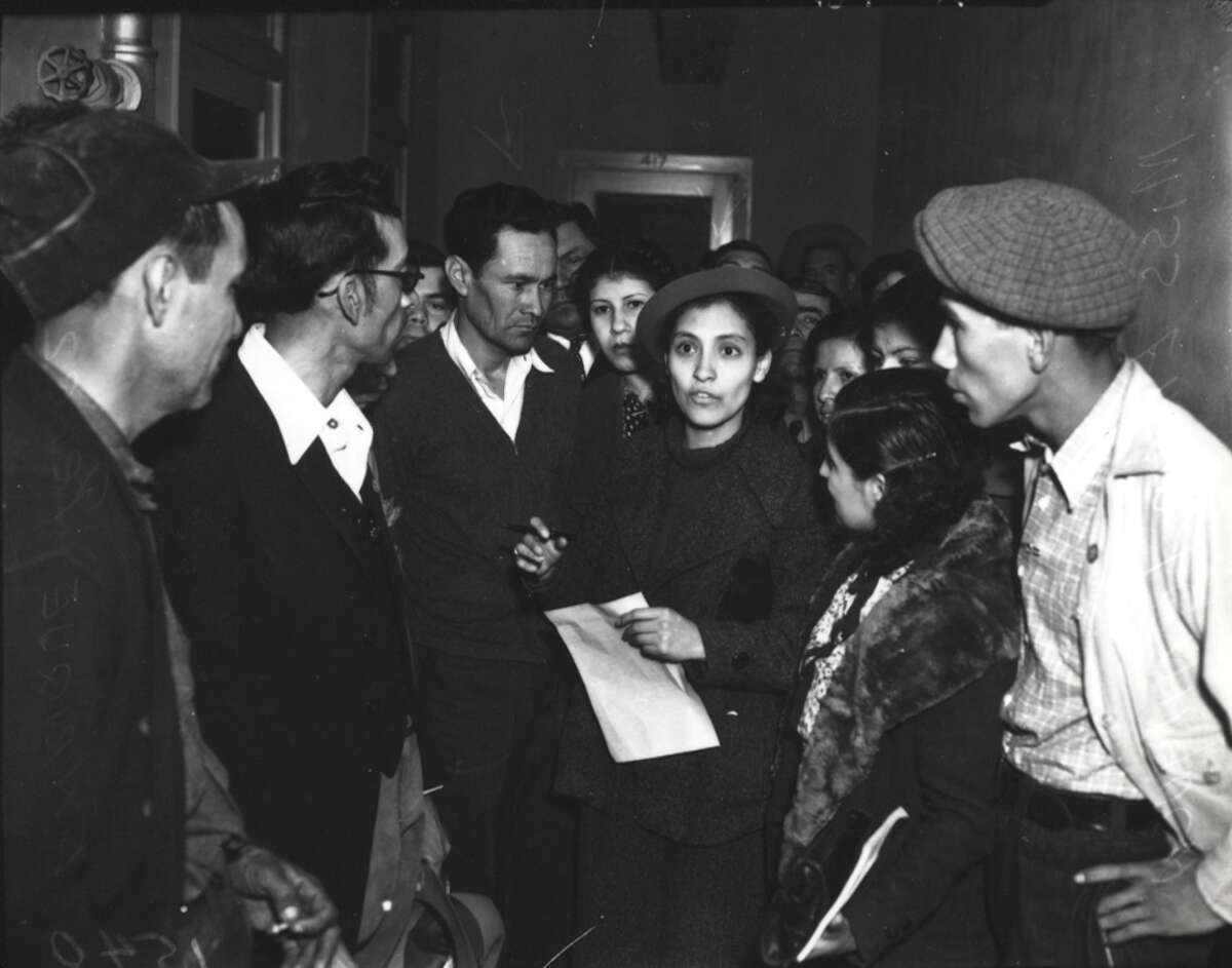 Activist Emma Tenayuca is surrounded by a crowd.