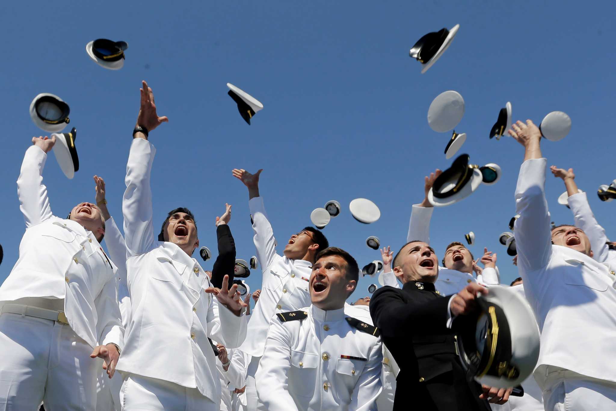 Naval Academy grads toss hats