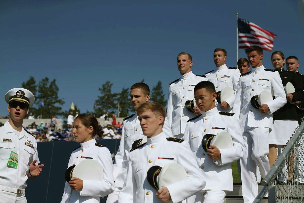 Naval Academy grads toss hats