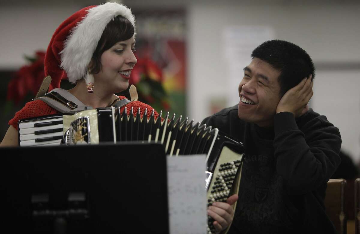 Heidi Hubrich (l to r), SPED transition teacher, and Ryan Lai, Community Access Transition student, sing together as they host a holiday sing-a-long with their class in the Library at Ruth Asawa School of the Arts on Tuesday, December 6, 2011 in San Francisco, Calif. The Community Access Transition classs in Room 208 at Ruth Asawa School of the Arts hosted a holiday sing-a-long to celebrate San Francisco Inclusive Schools week .