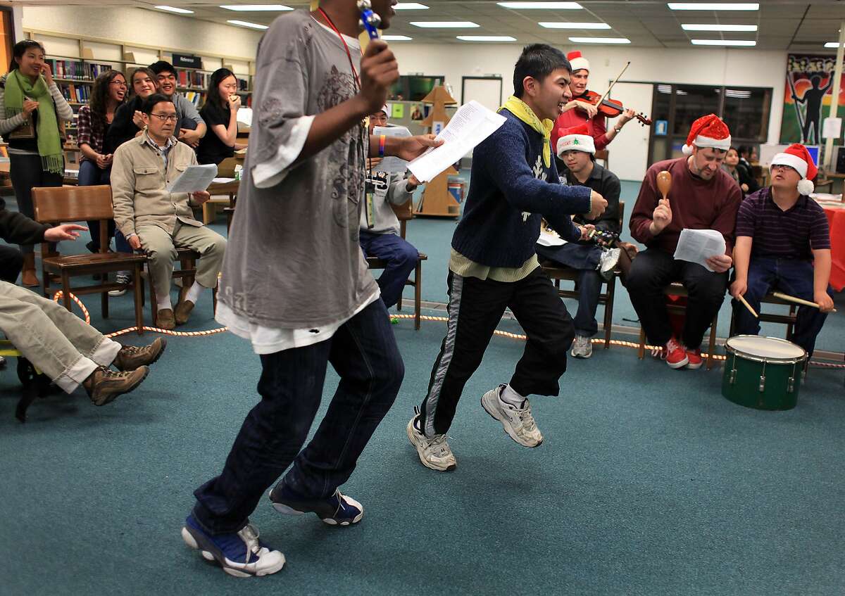 Alex Ng (right) and Demian Williams (left) , Community Access Transition students, dance together as they host a holiday sing-a-long with their class in the Library at Ruth Asawa School of the Arts on Tuesday, December 6, 2011 in San Francisco, Calif. The Community Access Transition classs in Room 208 at Ruth Asawa School of the Arts hosted a holiday sing-a-long to celebrate San Francisco Inclusive Schools week .