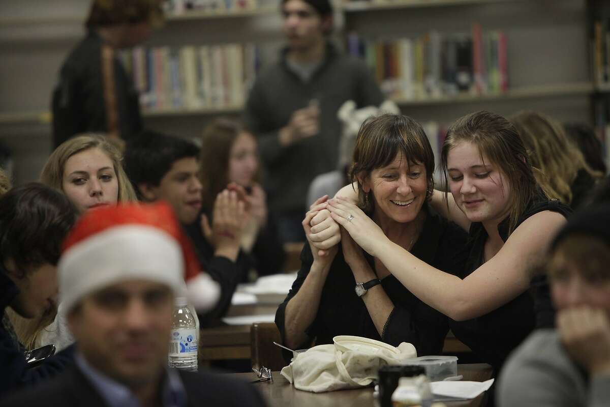 Mother and daughter, Therese Foco (l to r) and Mimi Folco, 17 embrace as they sing together during the holiday sing-a-long hosted by the Community Access Transition class in the Library at Ruth Asawa School of the Arts on Tuesday, December 6, 2011 in San Francisco, Calif. Therese is the Italian teacher at and Mimi is a senior at Ruth Asawa School of the Arts. The Community Access Transition Class in Room 208 at Ruth Asawa School of the Arts hosted a holiday sing-a-long to celebrate San Francisco Inclusive Schools week .