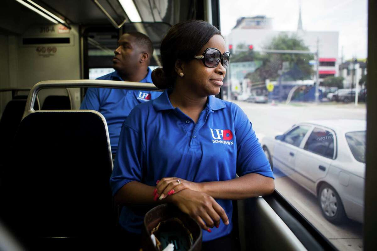 Sherrigo McNeil, foreground, and Brian Blackwell take a ride toward downtown Houston on the new Green Line Metro to pick up their cars after going to the The University of Houston Downtown Spring 2015 Commencement exercises at Minute Maid Park on May 23.