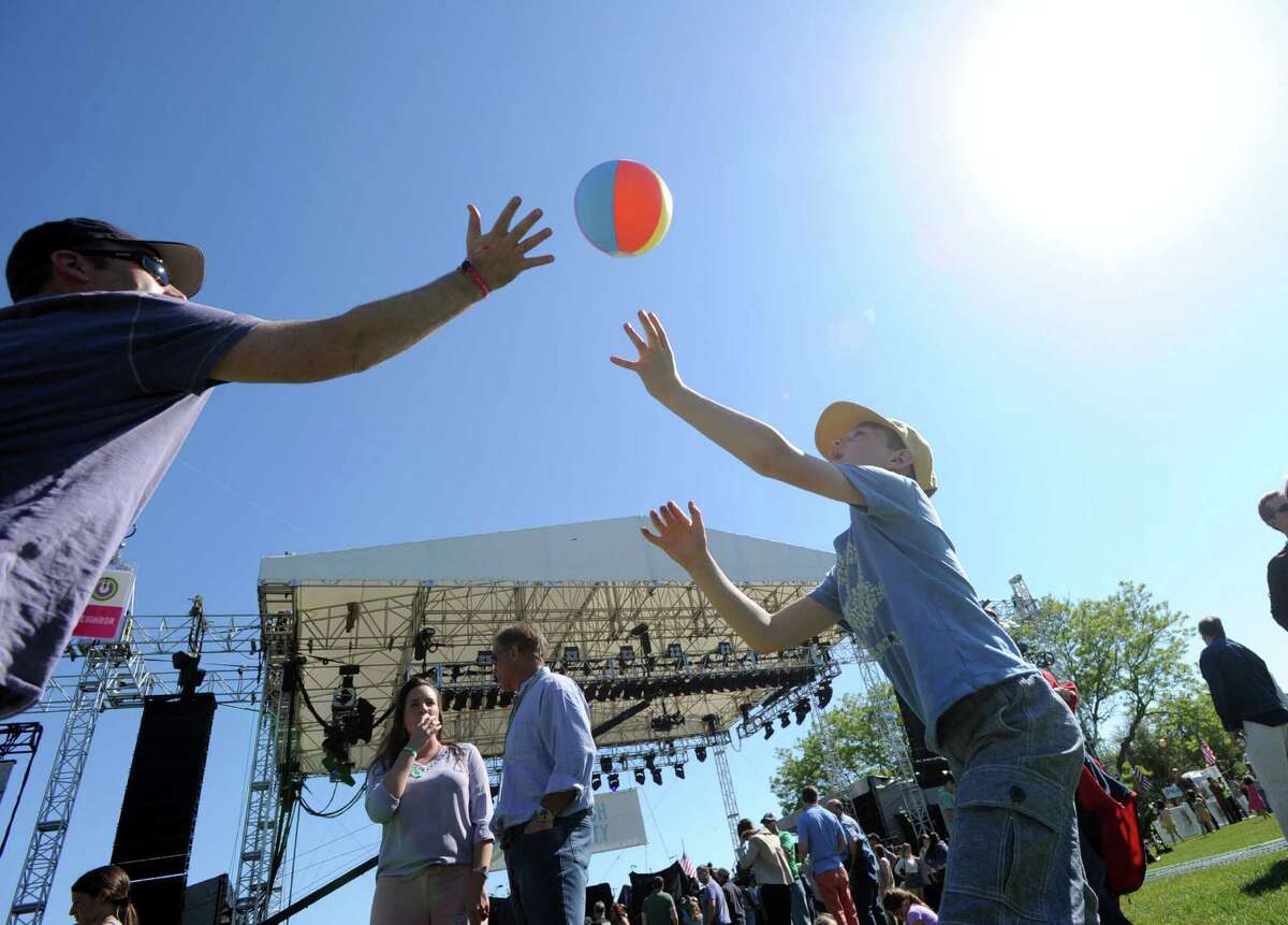 Larchmont, N.Y., resident, Peter Mundheim, left, and his son, Connor, 9, play with a beach-ball durng the Greenwich Town Party at Roger Sherman Baldwin Park, Greenwich, Conn., Saturday, May 23, 2015.
