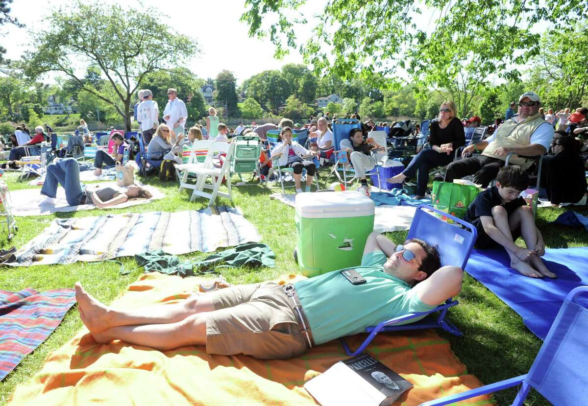 John Rinello of Greenwich relaxes on a blanket durng the Greenwich Town Party at Roger Sherman Baldwin Park, Greenwich, Conn., Saturday, May 23, 2015.