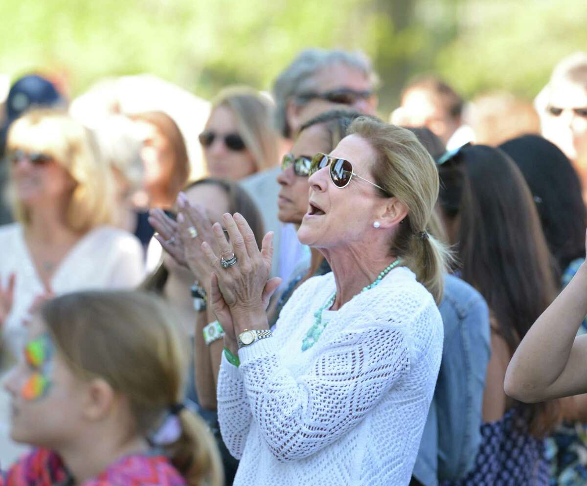 Lisa Cooper of Greenwich applauds the Greenwich band King's Highway durinng the Greenwich Town Party at Roger Sherman Baldwin Park, Greenwich, Conn., Saturday, May 23, 2015.