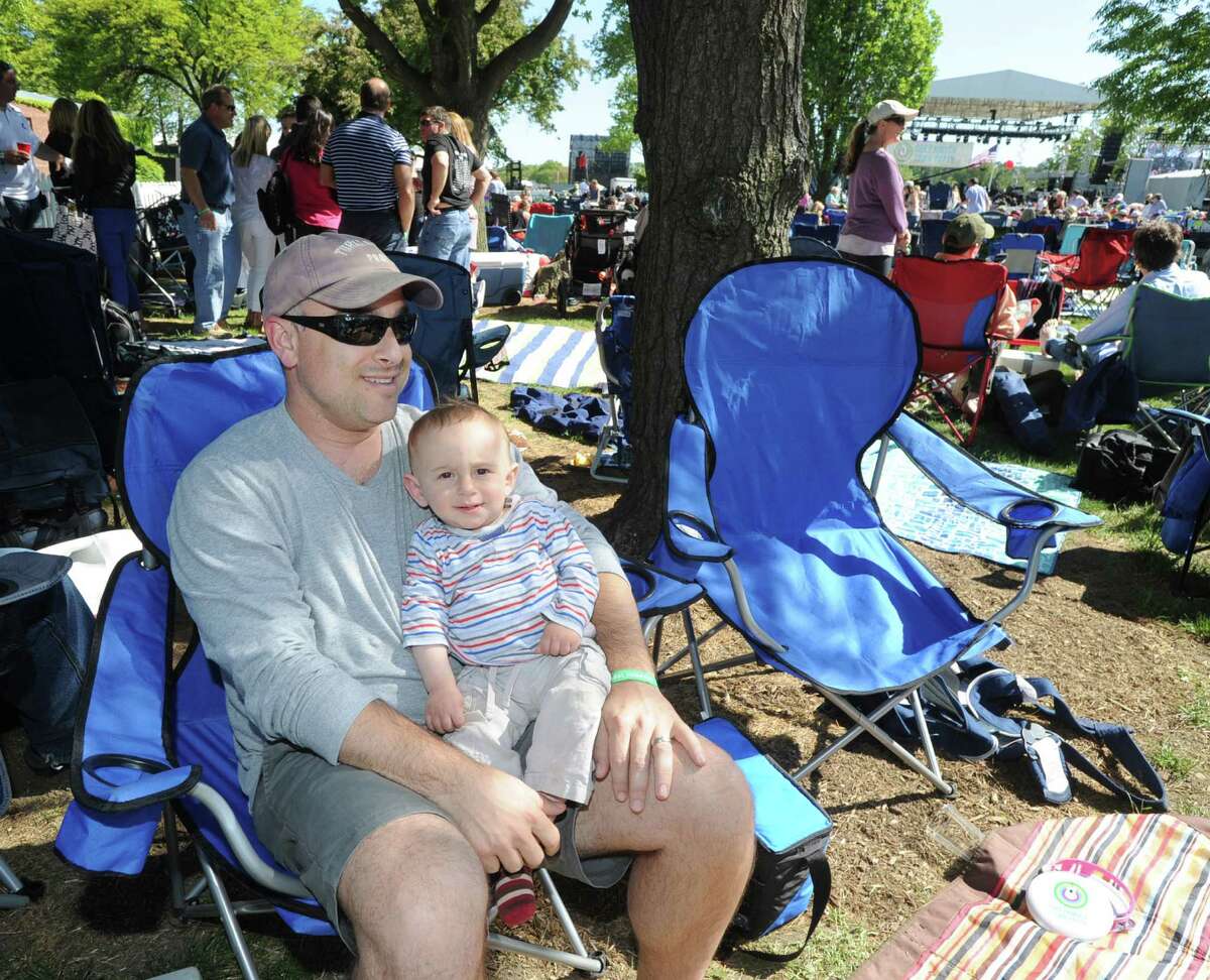 Michael Shore of Cos Cob and his son, Ethan, 9-months, during the Greenwich Town Party at Roger Sherman Baldwin Park, Greenwich, Conn., Saturday, May 23, 2015.
