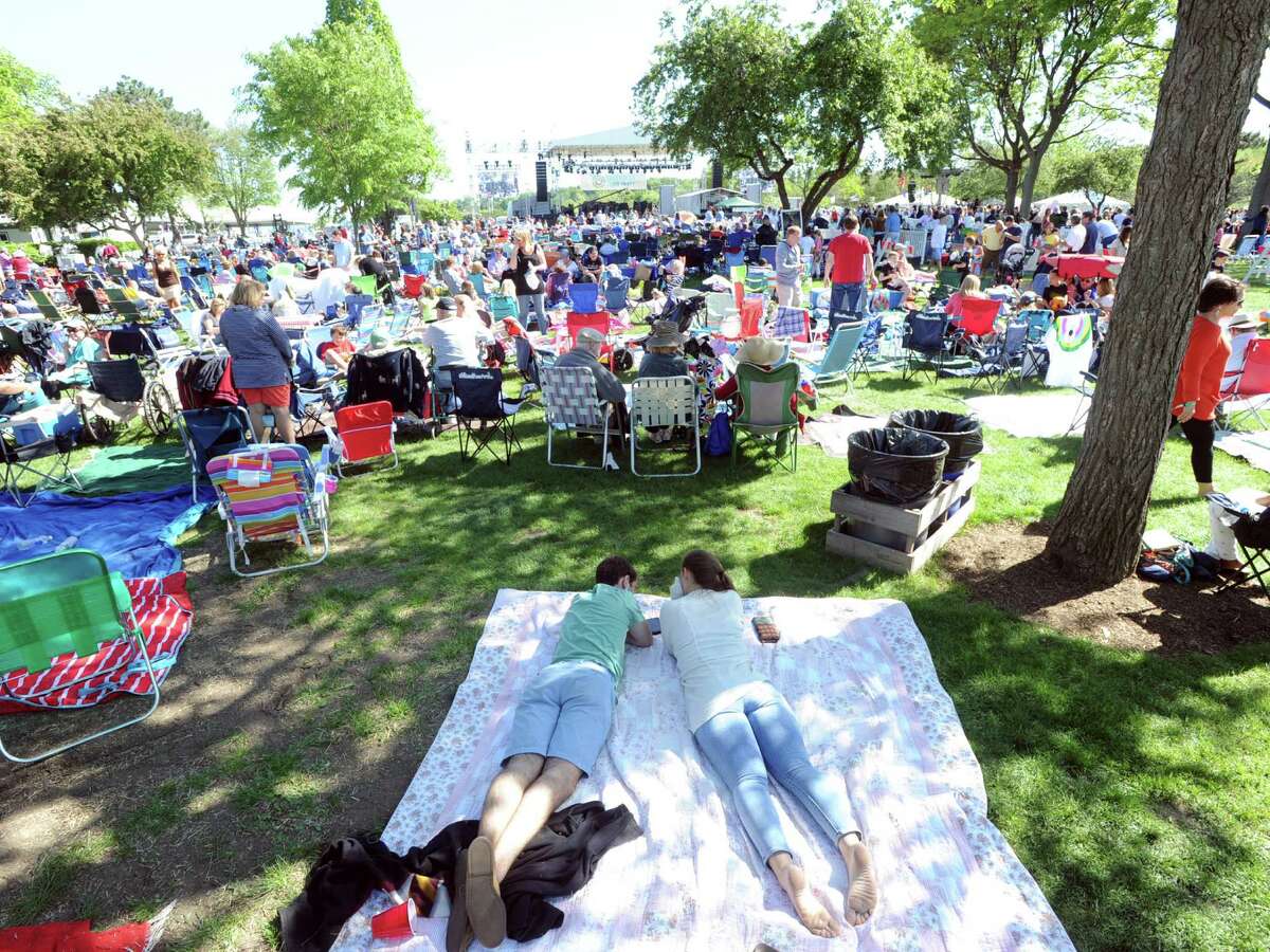 Greenwich residents Andrew Israel, left, and Katie Morena, sit on a blanket as they attended the Greenwich Town Party at Roger Sherman Baldwin Park, Greenwich, Conn., Saturday, May 23, 2015.